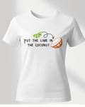 White t-shirt with a graphic design of a coconut and lime, text 'Put the lime in the coconut', on a light gray background.