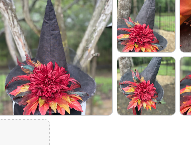 Amber Blaze witch hat — deep charcoal crown with crimson dahlia bloom and amber autumn maple leaves, photographed outdoors